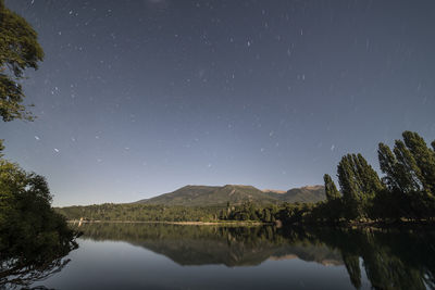 Scenic view of lake against sky at night