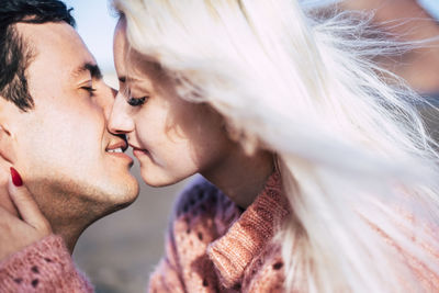 Portrait of couple kissing outdoors