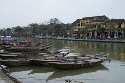 Boats moored in lake against clear sky