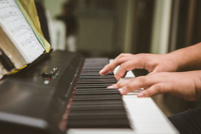 Midsection of man playing piano