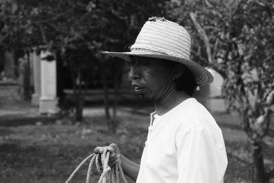 Side view of man wearing hat looking away