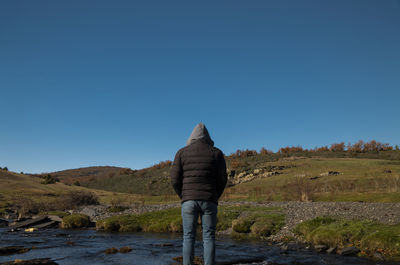 Portrait of adult man in countryside with river against blue sky, in guadalajara, spain