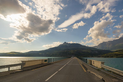 Road by river against sky