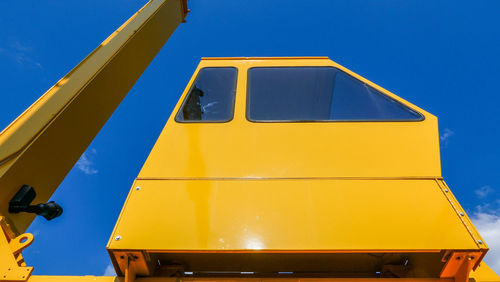Low angle view of yellow airplane against clear blue sky