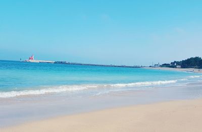 Scenic view of beach against clear sky