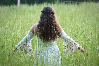 Rear view of woman in field