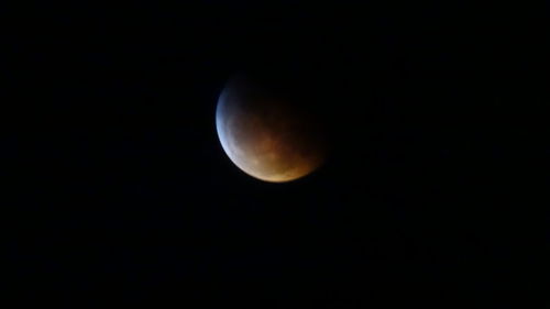 Low angle view of moon against sky at night