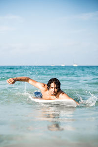 Young woman swimming in sea