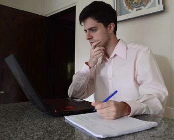 Young man using laptop at home