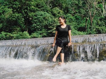 Full length of man in forest against river