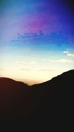 Scenic view of silhouette mountains against sky at sunset