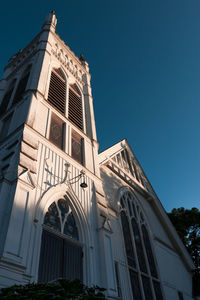 Low angle view of building against clear blue sky