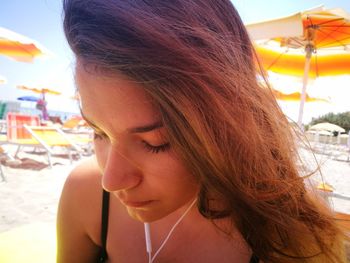 Close-up portrait of young woman looking down