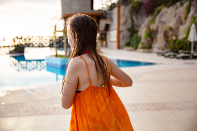 Rear view of woman standing in water