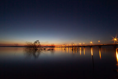 Scenic view of lake against sky at night