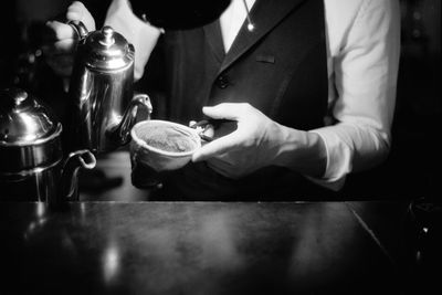 Midsection of man preparing food