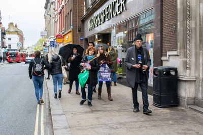 People walking on street in city