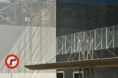 Close-up of road sign against building