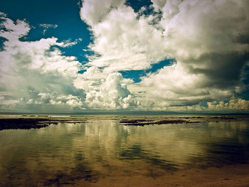 Scenic view of sea against cloudy sky