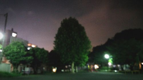 Illuminated street light in city at night