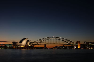 View of bridge over city at night