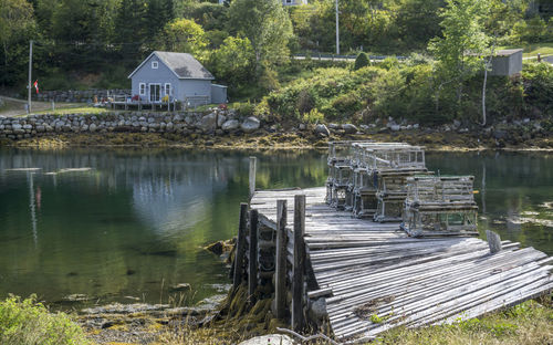 Scenic view of lake by trees and houses