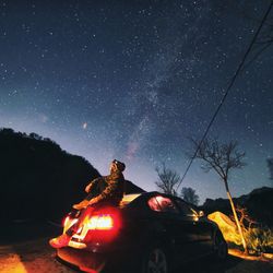 Low angle view of illuminated fire against sky at night