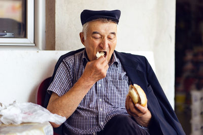 Midsection of man eating food