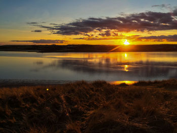 Scenic view of lake at sunset