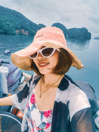 Portrait of woman in boat against sea