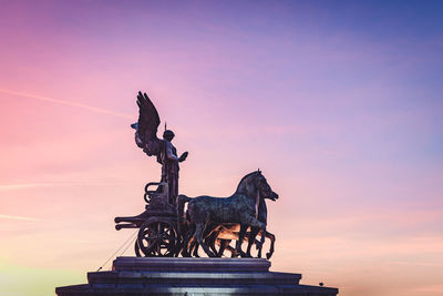 Low angle view of statue against sky during sunset