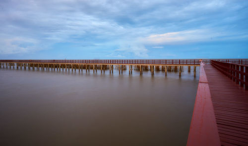 View of jetty at calm sea against the sky