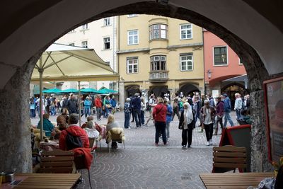 People at town square seen from archway