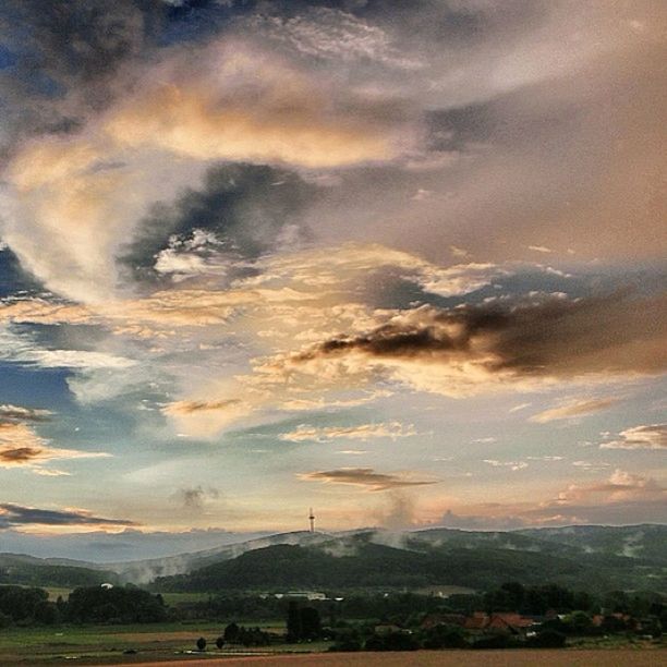 landscape, sky, cloud - sky, scenics, tranquil scene, beauty in nature, tranquility, cloudy, field, sunset, nature, tree, rural scene, building exterior, built structure, weather, architecture, cloud, high angle view, dramatic sky