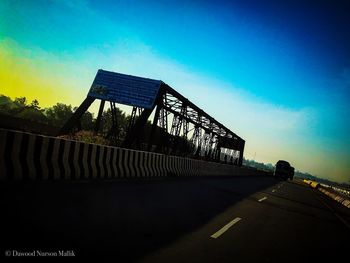 Silhouette of bridge against blue sky