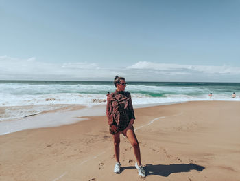 One girl standing in the beach of praia da adraga