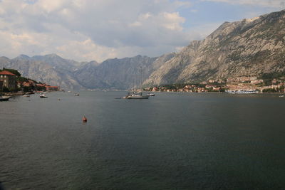 Scenic view of sea and mountains against sky