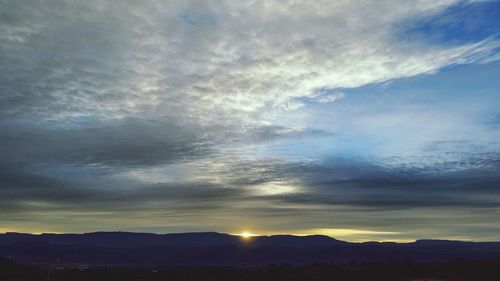 Scenic view of mountains against sky at sunset