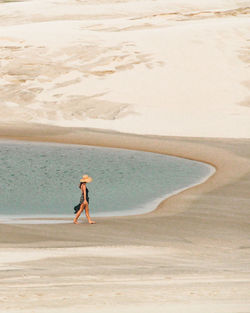 Full length of woman walking at beach