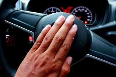 Close-up of hand holding car