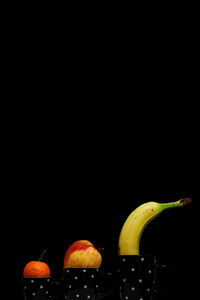 Close-up of fruit over black background