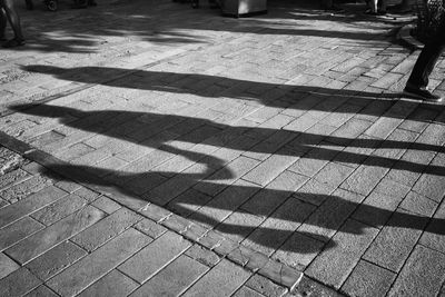 Shadow of person on footpath