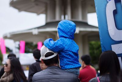 Group of people against blue sky