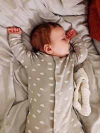 Portrait of cute baby boy sleeping on bed