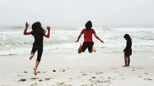 Rear view of children at beach