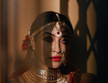 Portrait of beautiful bride against wall