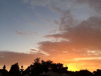 Silhouette trees against sky during sunset