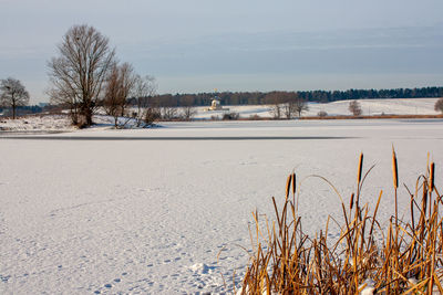 Scenic view of frozen field against sky