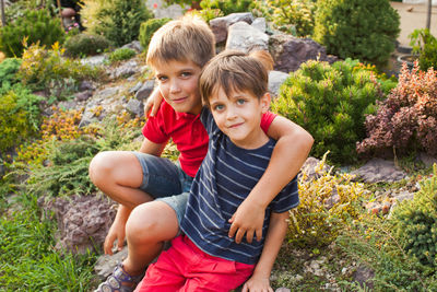 Portrait of boy and mother on field