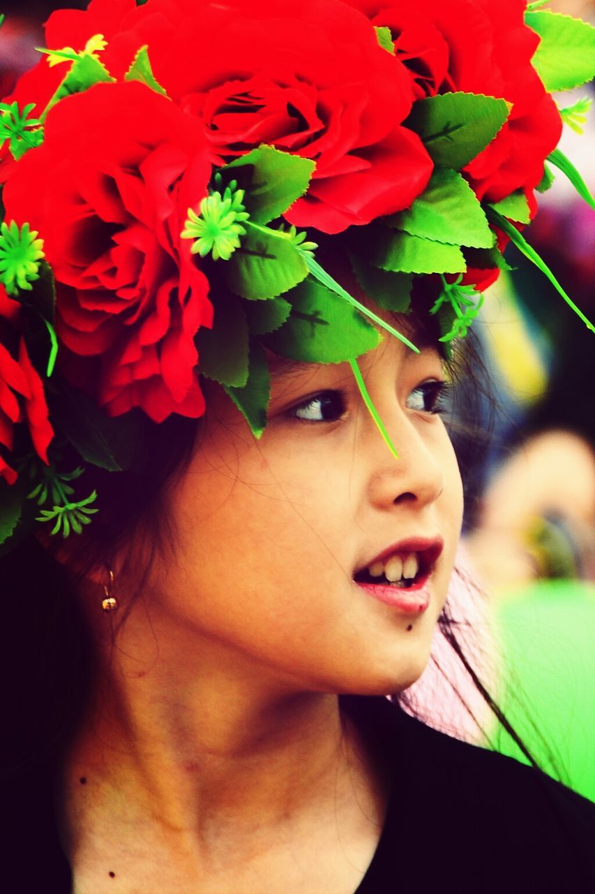 flower, fragility, close-up, freshness, red, person, petal, headshot, lifestyles, flower head, focus on foreground, growth, childhood, portrait, looking at camera, plant, rose - flower, nature